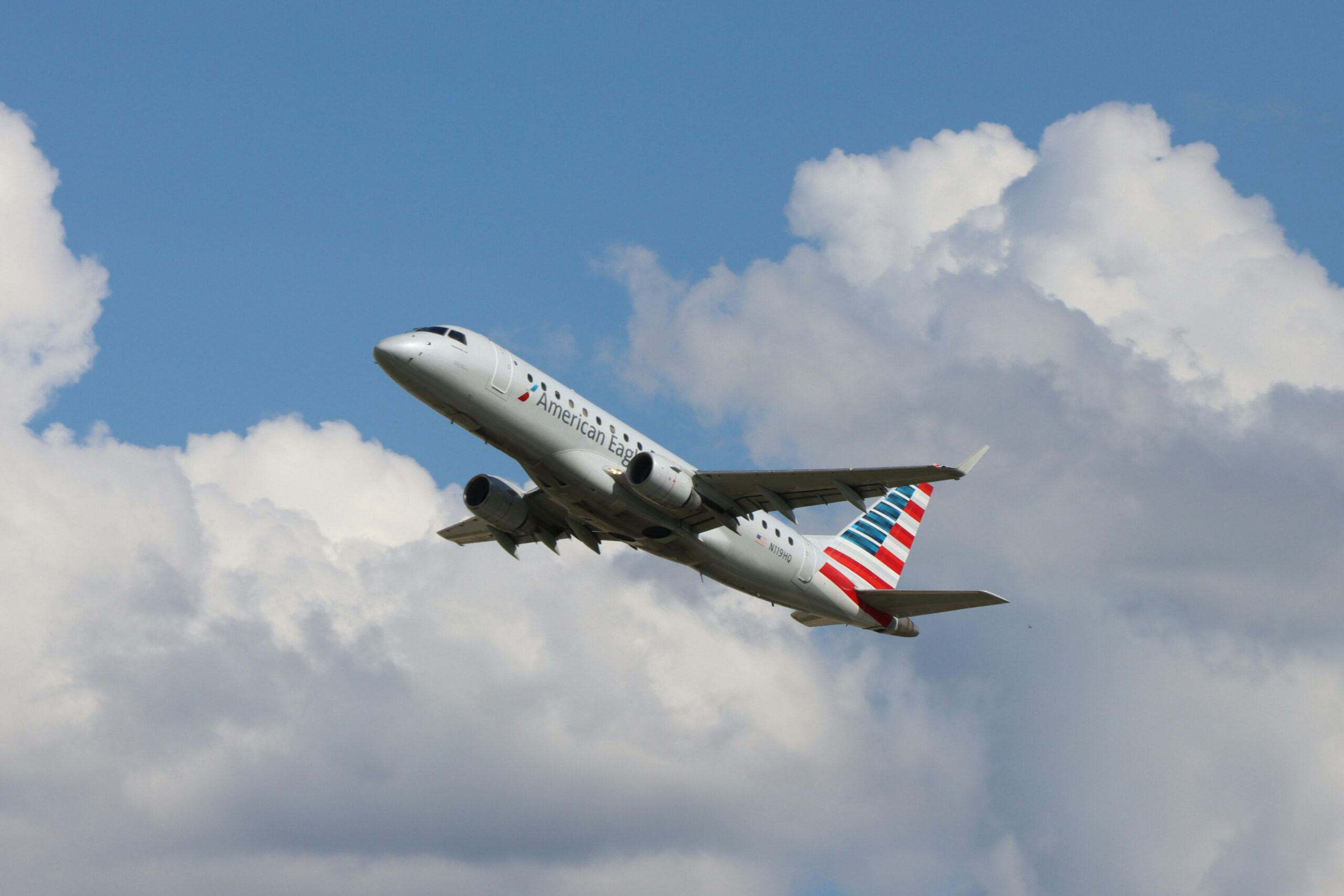 American Airlines plane flying through the blue sky