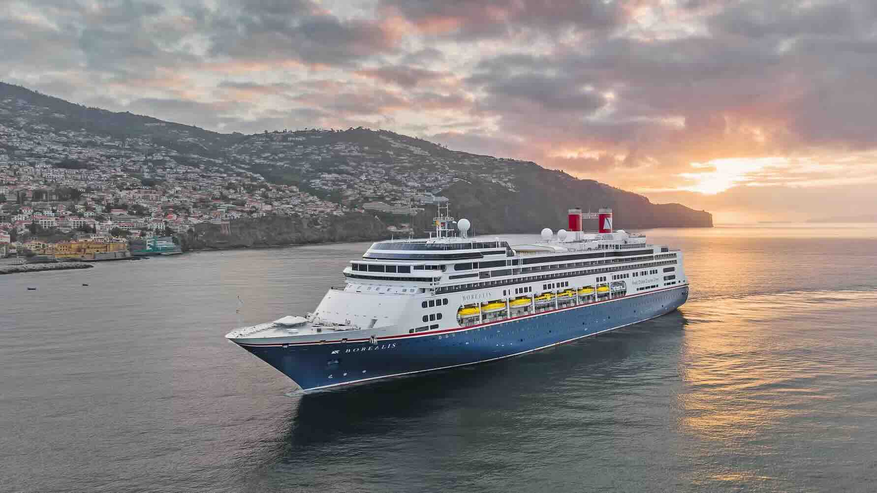 Fred. Olsen cruise ship pictured with sunset in the background.