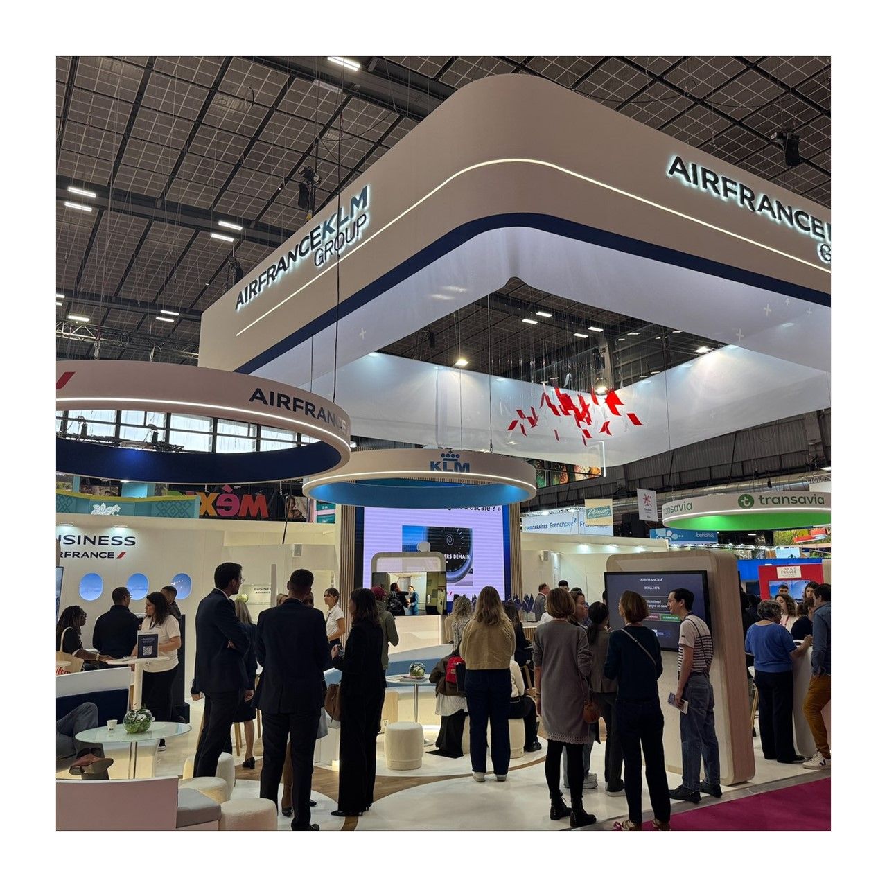 Air France stand at a trade show, people standing around chatting.